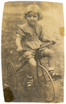 Virginia Garrett riding a tricycle