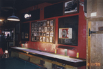 Red Wall with Framed Photographs
