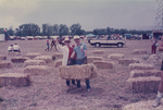 Joseph K. Dulle and Woman with a bale of Hay