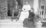 Personal postcard photograph of Adeline de Valcourt Kendall, Dane and Mr. Dane sitting on their porch