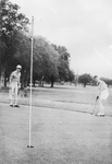 Carolyn Taylor watches Jessie Ambrose putt