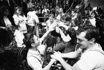 University of Texas at Arlington (U. T. A.) Movin' Mavs wheelchair basketball team members celebrate Final Four victory, 03/09/1994