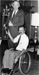 University of Texas at Arlington (U. T. A.) President Dr. W. H. Nedderman presenting trophy to Movin' Mavs wheelchair basketball coach Jim Hayes