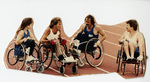 Jim Hayes and others in racing chairs on an athletic track