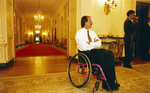 Jim Hayes in wheelchair at end of ornate White House hallway