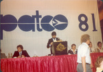 Three men on stage with sign behind them that reads "PATCO 81"" "PATCO 81 reads PATCO, Tehas