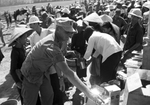 U.S. soldier distributing food and supplies in the Vietnam War