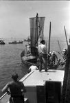Unidentified men on boats