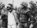 Unidentified soldiers and prisoner