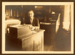 John L. Rogers working at desk