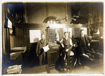 Three men in a Fort Worth office; Otto Schmidt in center