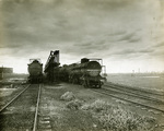 Two railroad tanker cars surround a Pierce Fordyse Oil Association loading rack