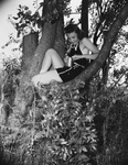 Woman in tree with fishing pole by Squire Haskins Photography Inc.