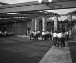 Several men, some of them wearing leis, are at an outdoor reception by Squire Haskins Photography Inc.