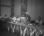 Several men are seated at a dais. with a decorate the table. by Squire Haskins Photography Inc.