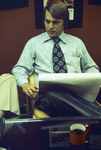 Young businessman seated wearing a tie and dress shirt by Squire Haskins Photography Inc.