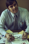 Young businessman seated wearing a tie and dress shirt by Squire Haskins Photography Inc.