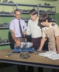 Mechanical arts instructor with two students by Squire Haskins Photography Inc.