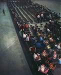 Men and women sitting in a large exhibit hall. Several of the men are wearing Shriners hats by Squire Haskins Photography Inc.