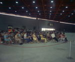 Men and women sit on folding metal chairs by Squire Haskins Photography Inc.