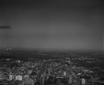 Aerial view of downtown Dallas. There is a bi-plane flying in the left side of the photograph by Squire Haskins Photography Inc.