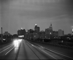 Evening photograph. Bridge over the Trinity River with downtown Dallas, Texas in the distance by Squire Haskins Photography Inc.