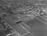 Football stadium at Southern Methodist University, Dallas, Texas. The stands are filled while the game is being played. The Goodyear Blimp is flying over the stadium by Squire Haskins Photography Inc.