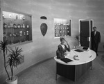 Pfizer Company. Receptionist seated in front of product cases by Squire Haskins Photography Inc.