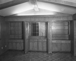 Whittington residence. Wood-paneled wall with bookcases and a wet bar by Squire Haskins Photography Inc.