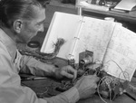 Man working with electrical components by Squire Haskins Photography Inc.