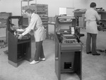 Two men working in what appears to be an electronics shop by Squire Haskins Photography Inc.