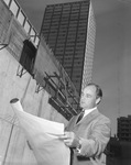 Architect Thomas E. Stanley in front of the First National Bank building under construction by Squire Haskins Photography Inc.