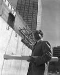 Architect Thomas E. Stanley in front of the First National Bank building under construction by Squire Haskins Photography Inc.