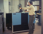 Man operating a Saxon copier by Squire Haskins Photography Inc.