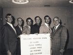 Group of men holding a "Welcome Houston Stars" sign. by Squire Haskins Photography Inc.