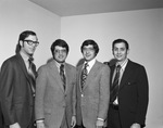 Four men standing in a row, names unknown by Squire Haskins Photography Inc.