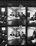 Photograph proofs of three men, seated, reviewing paper documents by Squire Haskins Photography Inc.