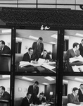 Photograph proofs of three men, one standing and two seated, reviewing printed documents by Squire Haskins Photography Inc.