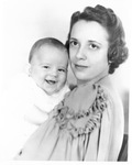 Photograph of a woman holding a baby, persons unknown by Squire Haskins Photography Inc.