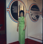 Woman standing in and exhibit of the Cable & Wireless Company by Squire Haskins Photography Inc.