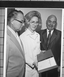 Doris J. Wilson, RN, showing the Dallas area diet manual 1972 booklet to two men in suits by Squire Haskins Photography Inc.