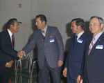 Four men talking, two are shaking hands by Squire Haskins Photography Inc.