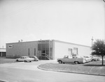 Building with cars in parking lot by Squire Haskins Photography Inc.