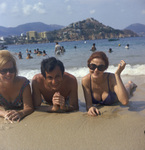 Vacationers relaxing on a beach, possibly in Mexico by Squire Haskins Photography Inc.