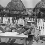 Vacationers relaxing on a beach by Squire Haskins Photography Inc.