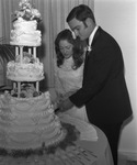 Bride and groom cutting their wedding cake by Squire Haskins Photography Inc.