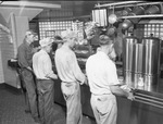 Cafeteria with four men waiting in line by Squire Haskins Photography Inc.