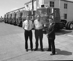 Men posing in front of a warehouse and Briggs semi truck cabs by Squire Haskins Photography Inc.