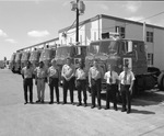 Men posing in front of a warehouse and Briggs semi truck cabs by Squire Haskins Photography Inc.