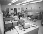 Office workers seated at desks by Squire Haskins Photography Inc.